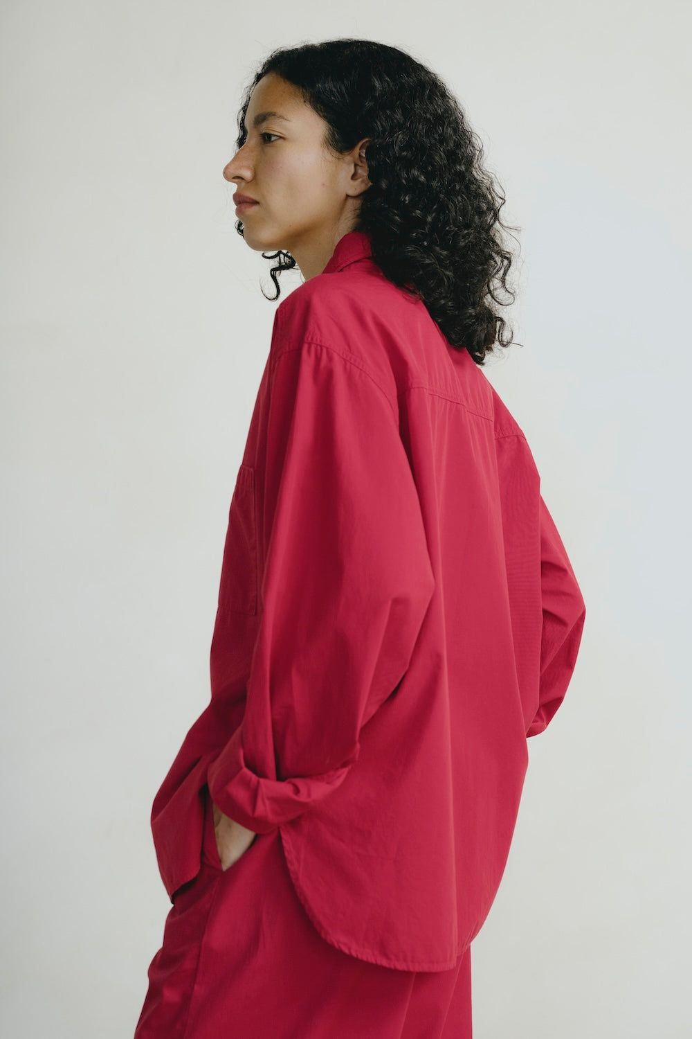 Person wearing a red outfit against a plain background